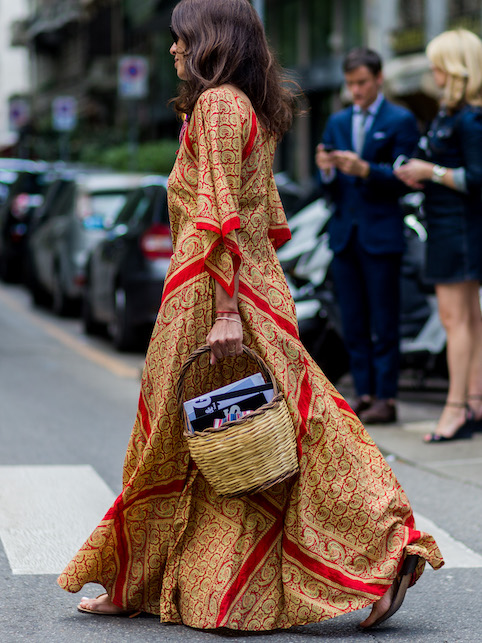 ragazza con abito stampato beige e rosso e cestino di paglia