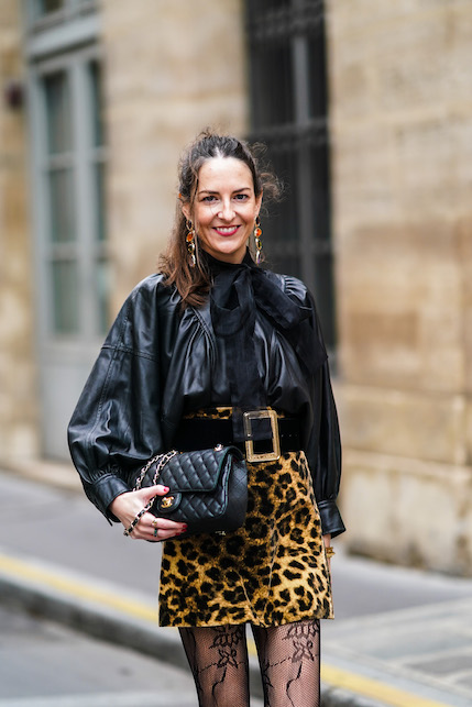 donna con camicia lavallière nera e gonna animalier